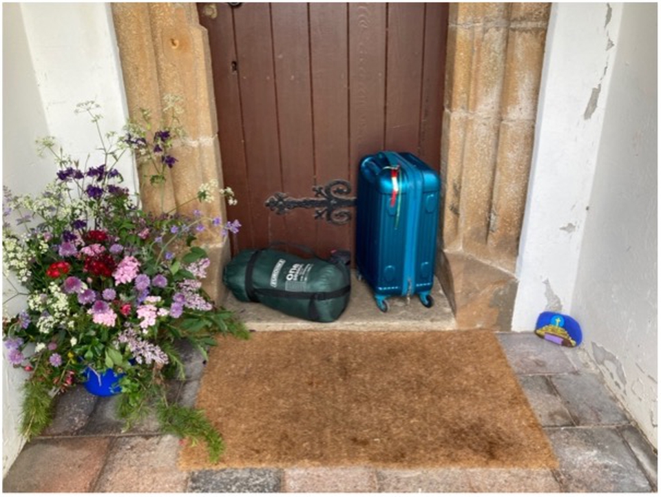 Suitcases outside the church door
