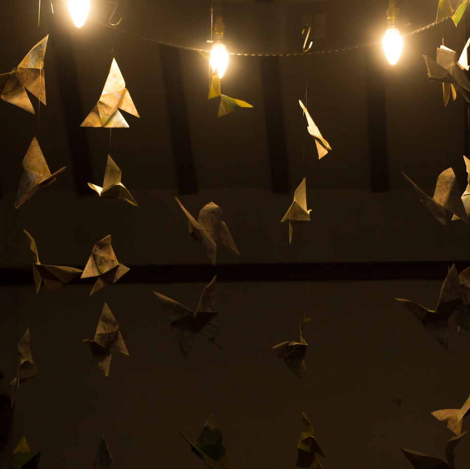 Strings of paper butterflies hanging from a light fitting in St Mary's Church